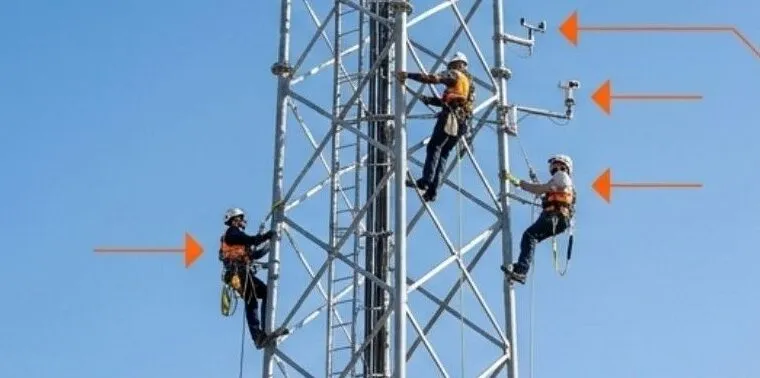 Technicians climbing a meteorological mast to service wind sensors
